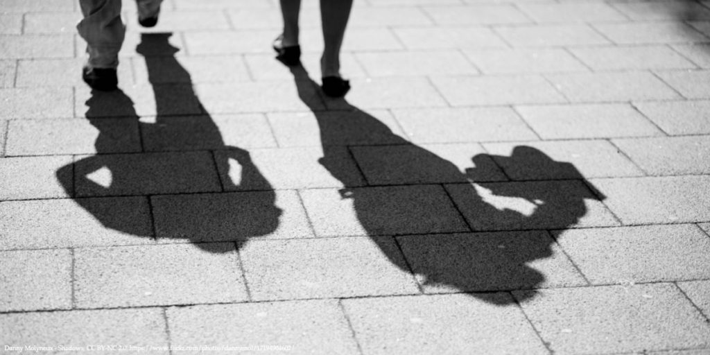 Policy Brief Image of Two Shadows from Walking Men Representing Shadow Economies