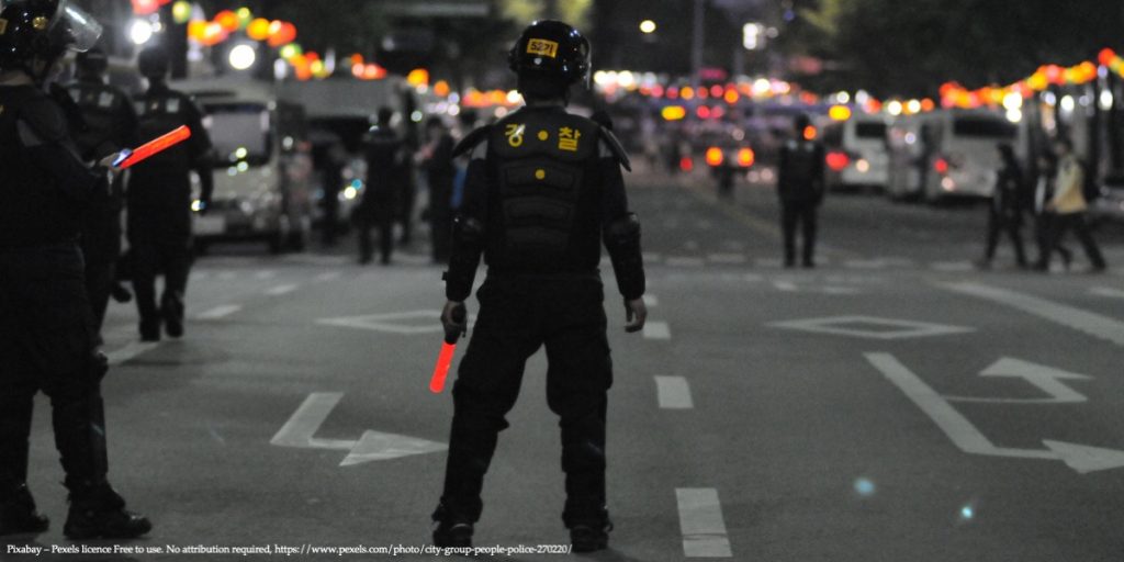 Image of a military man standing in the middle of the street representing coups and economic development