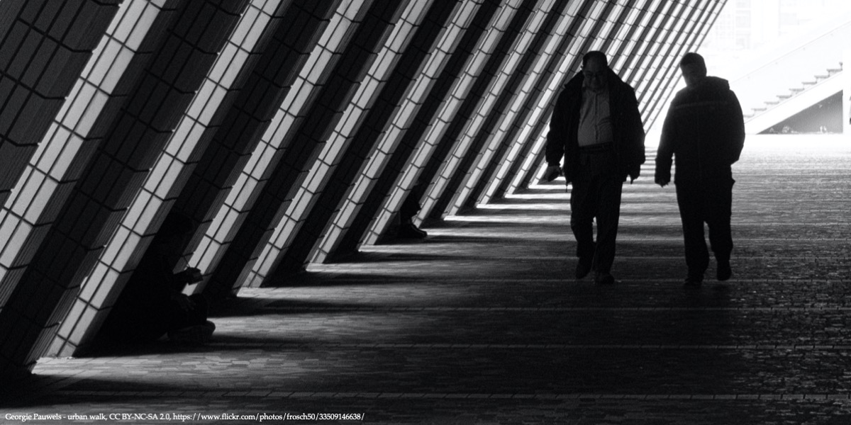 Tunnel with a light at the end with two men walking closer symbolising transition in Eastern Europe discussed during SITE conference