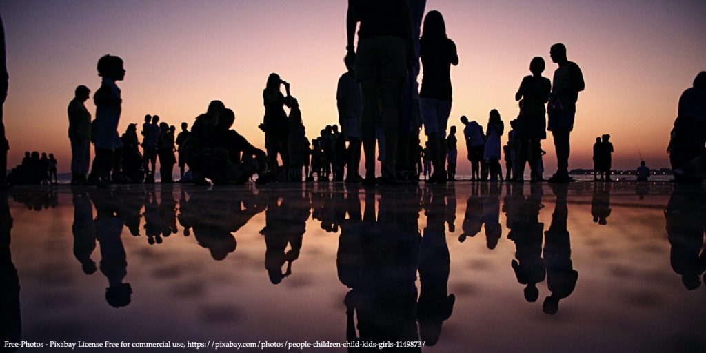 20200504 FREE Network Policy Brief image with dozen people standing at the seaside in sunset representing Women’s Representation in Politics Image 01