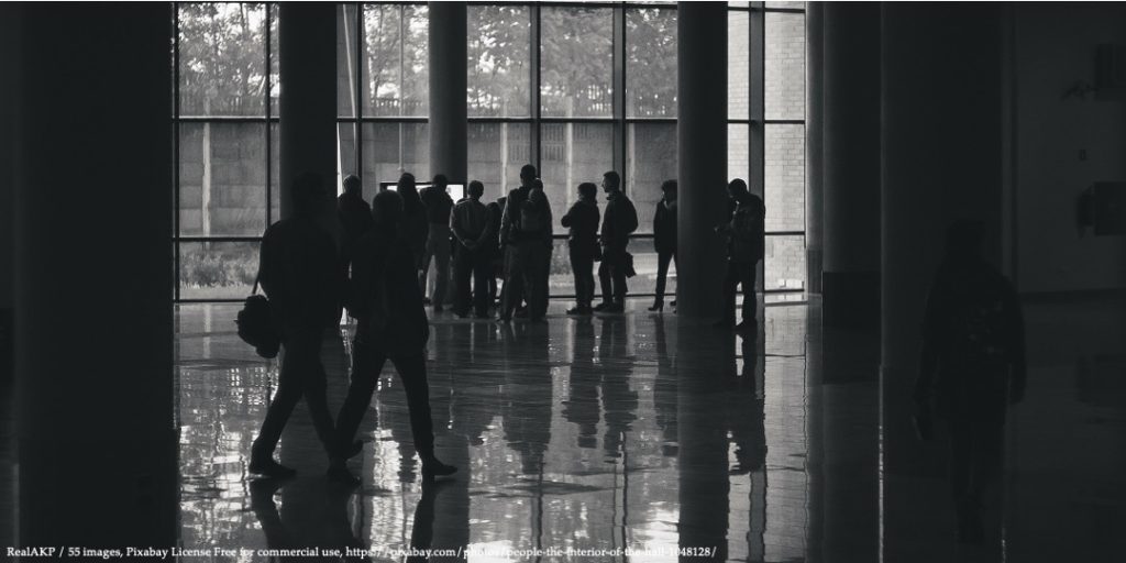 Image with people standing in a building representing whistleblowers During the Covid-19 Pandemic