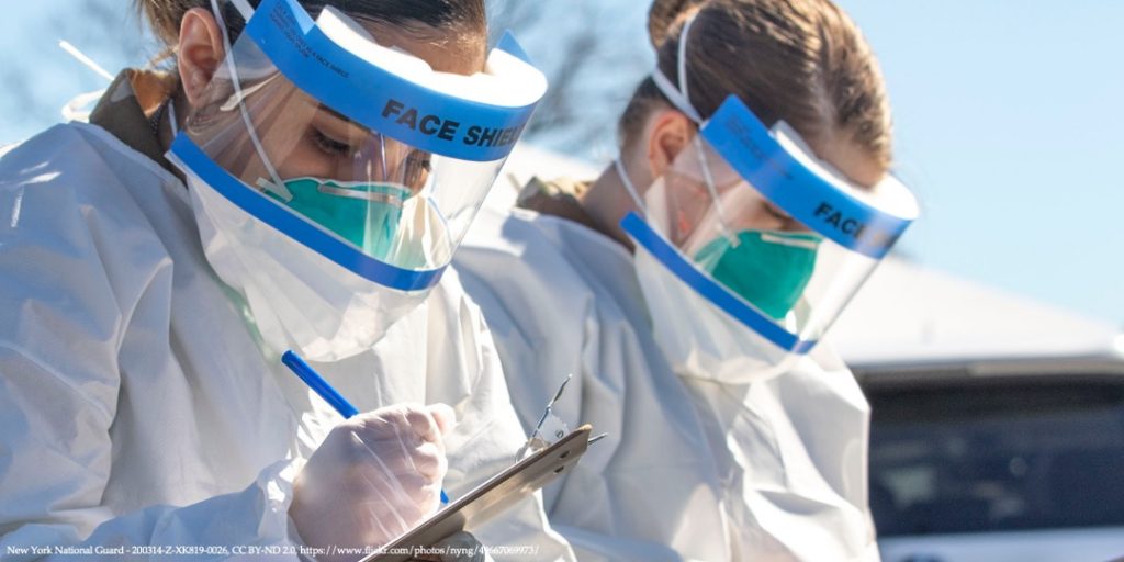 Image of two medical workers with face shields representing COVID-19 procurement