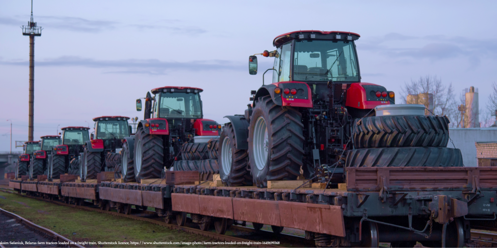 Image of farm tractor loaded on a freight train representing Belarus Under War Sanctions