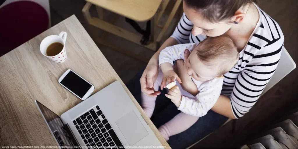 A working mother in Poland multitasking with her child, representing Active Parent Poland.