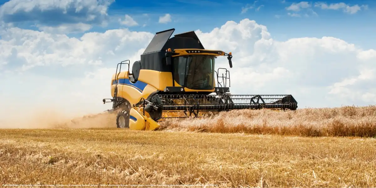 Combine harvester in a Ukrainian wheat field symbolizing EU accession impacts on agriculture.