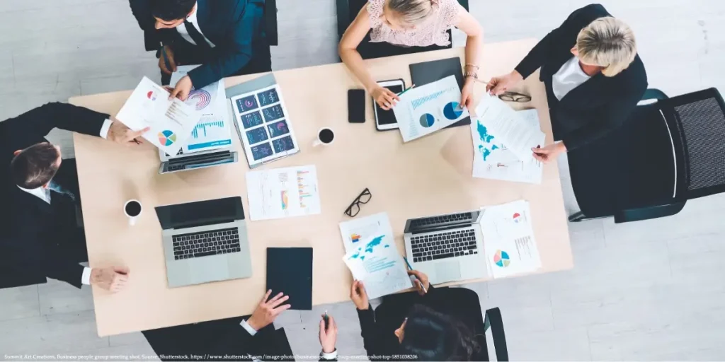 Top-down view of a team analyzing Gender Board Diversity statistics in a corporate setting.